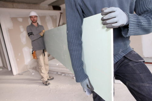 Workers Carrying Plasterboard.
