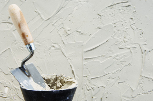 Trowel and stucco --- Image by © Peter Frank/Corbis
